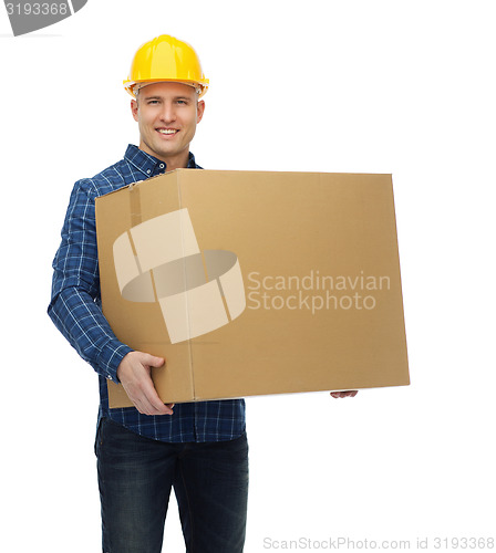 Image of smiling male builder in helmet with cardboard box