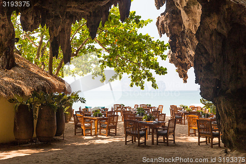 Image of view to open-air restaurant on beach from cave