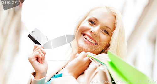 Image of woman with shopping bags in ctiy