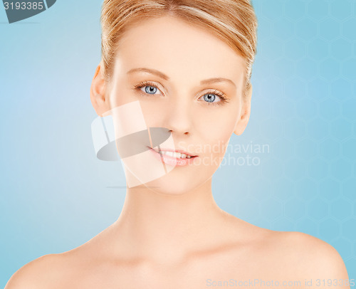 Image of beautiful young woman face over blue background