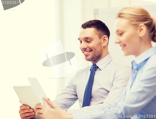 Image of business team working with tablet pc in office