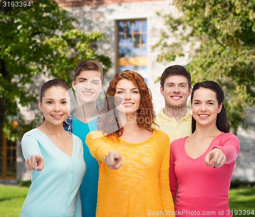 Image of group of smiling teenagers over campus background