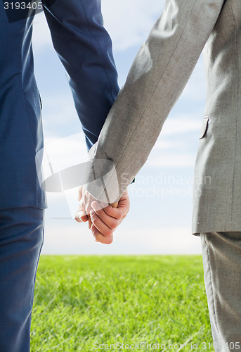 Image of close up of male gay couple holding hands