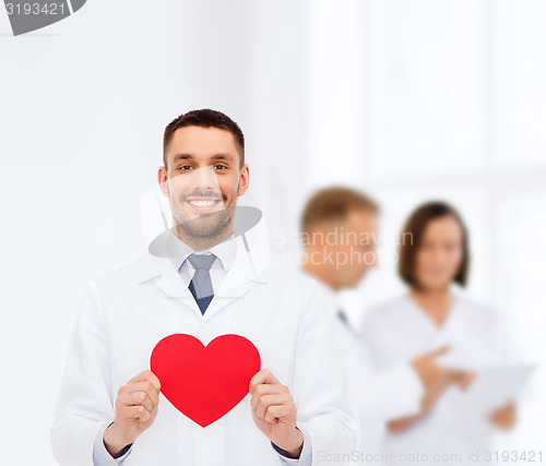 Image of smiling male doctor with red heart