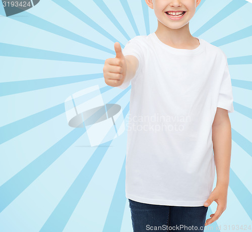 Image of close up of boy in white t-shirt showing thumbs