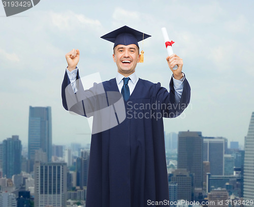 Image of smiling adult student in mortarboard with diploma