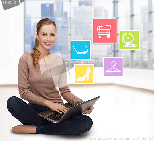 Image of smiling woman with laptop shopping online at home