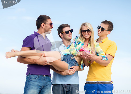 Image of group of friends having fun on beach