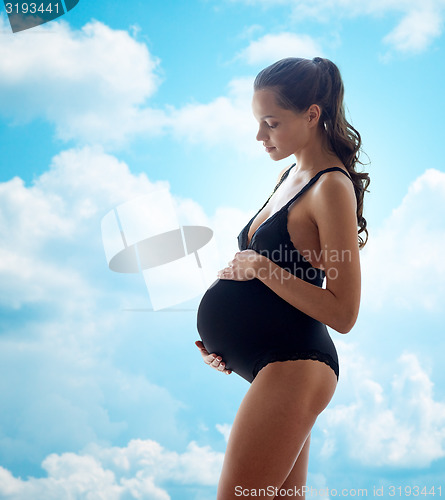 Image of happy pregnant woman in black underwear