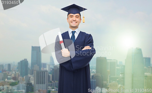 Image of smiling adult student in mortarboard with diploma