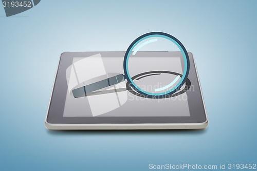 Image of tablet pc with magnifying glass icon over screen