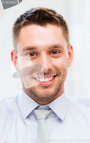 Image of businessman in office showign thumbs up