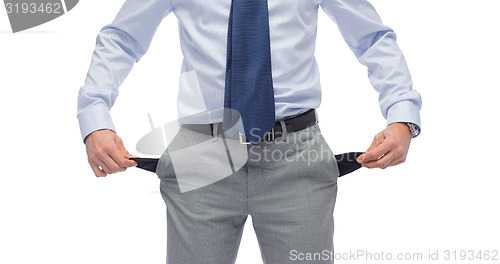 Image of close up of businessman showing empty pockets