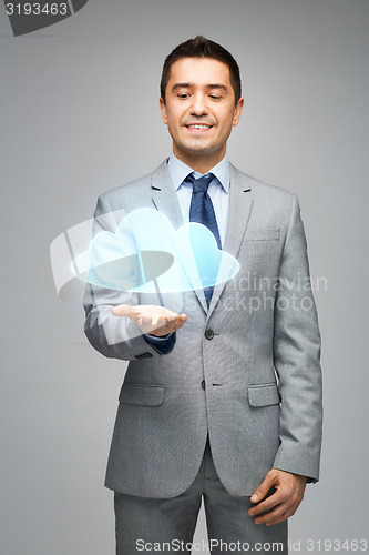 Image of happy businessman showing virtual cloud projection