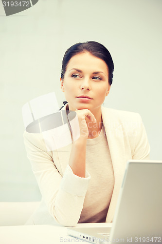Image of pensive woman with laptop computer