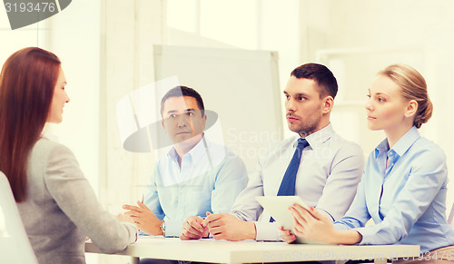 Image of business team interviewing applicant in office