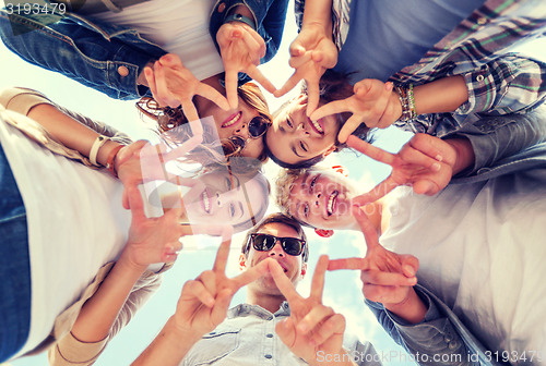 Image of group of teenagers showing finger five