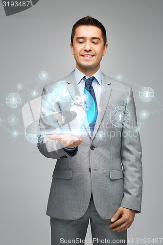 Image of happy businessman in suit showing global network