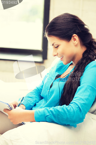 Image of happy woman with big notepad