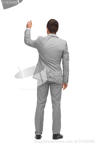 Image of businessman writing or drawing something imaginary