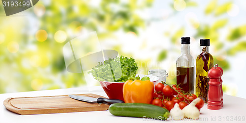 Image of vegetables, spices and kitchenware on table