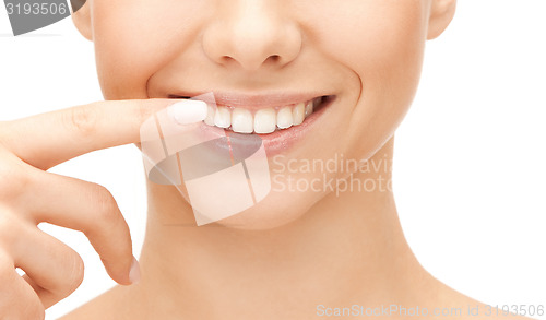 Image of beautiful woman pointing to teeth