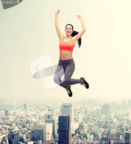 Image of sporty teenage girl jumping in sportswear