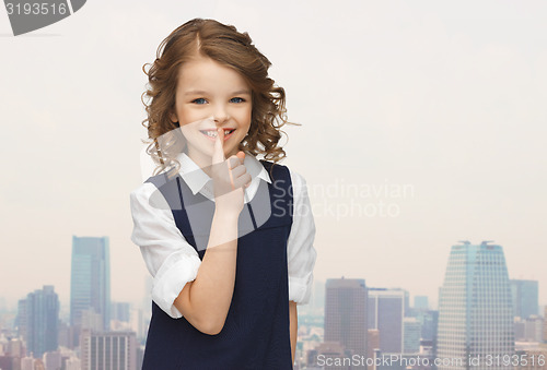 Image of happy girl showing hush gesture