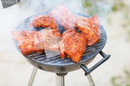 Image of close up of meat on barbecue grill outdoors