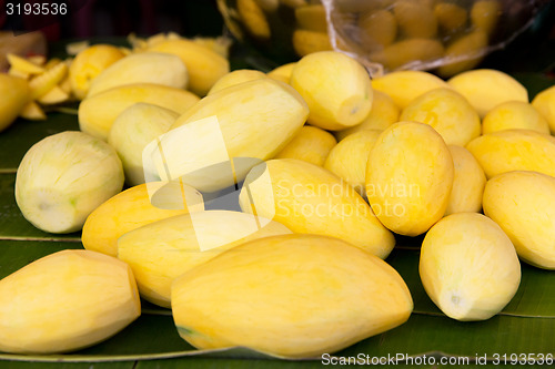 Image of peeled mango at street market