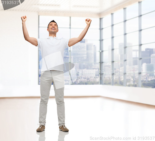 Image of happy man with raised hands