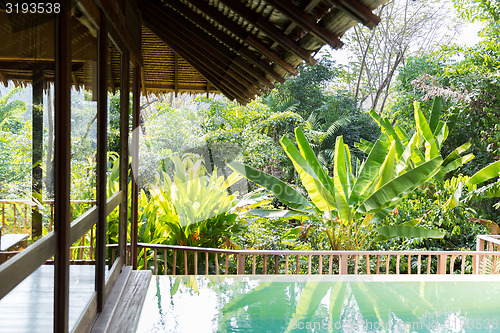 Image of swimming pool and bungalow at hotel resort