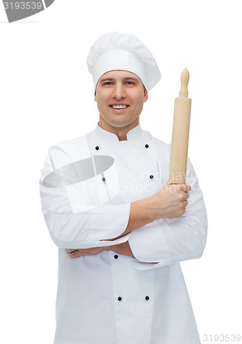 Image of happy male chef cook holding rolling pin