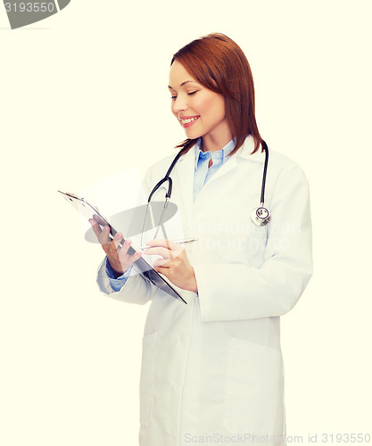 Image of smiling female doctor with clipboard