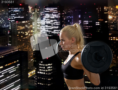 Image of sporty woman exercising with barbell