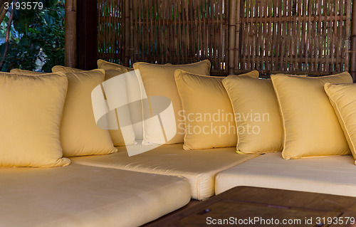 Image of couch with pillows at hotel terrace