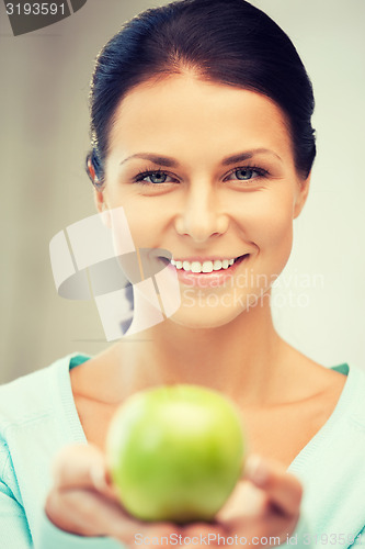 Image of lovely housewife with green apple