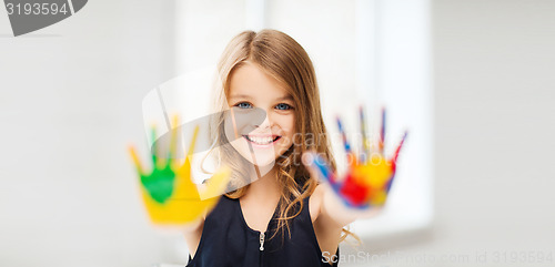 Image of smiling girl showing painted hands