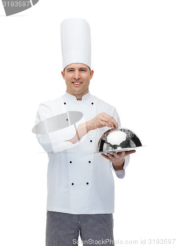 Image of happy male chef cook holding cloche