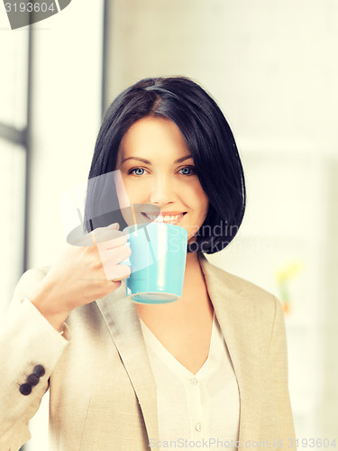 Image of lovely businesswoman with mug