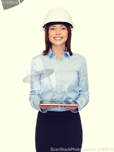 Image of young businesswoman in white helmet with tablet pc