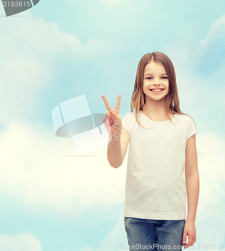 Image of little girl in white t-shirt showing peace gesture