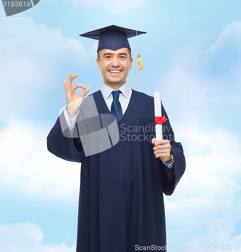 Image of smiling adult student in mortarboard with diploma