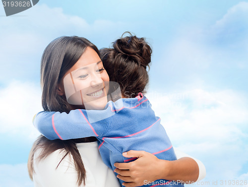 Image of happy mother and daughter hugging