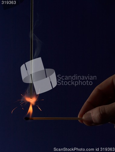 Image of Hand lighting a sparkler