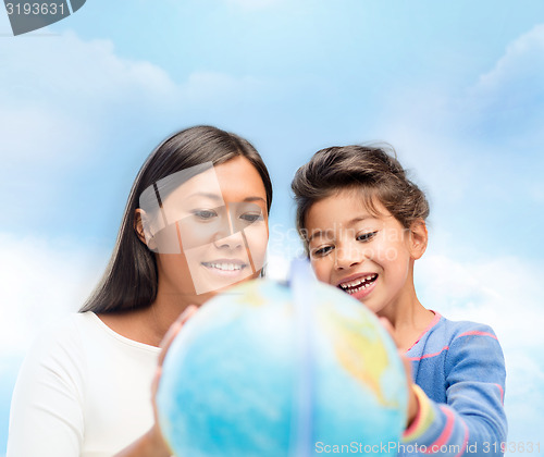 Image of mother and daughter with globe