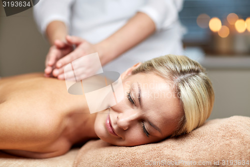 Image of close up of woman lying and having massage in spa