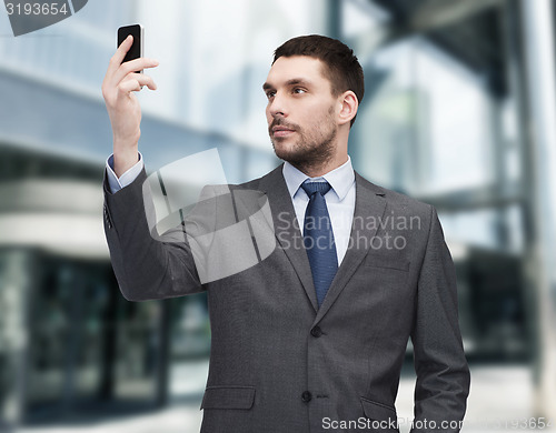 Image of young businessman with smartphone