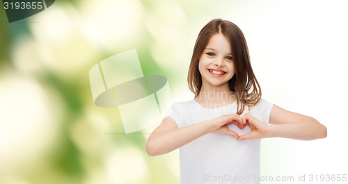 Image of smiling little girl in white blank t-shirt