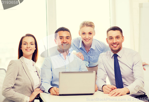 Image of business team working with laptop in office